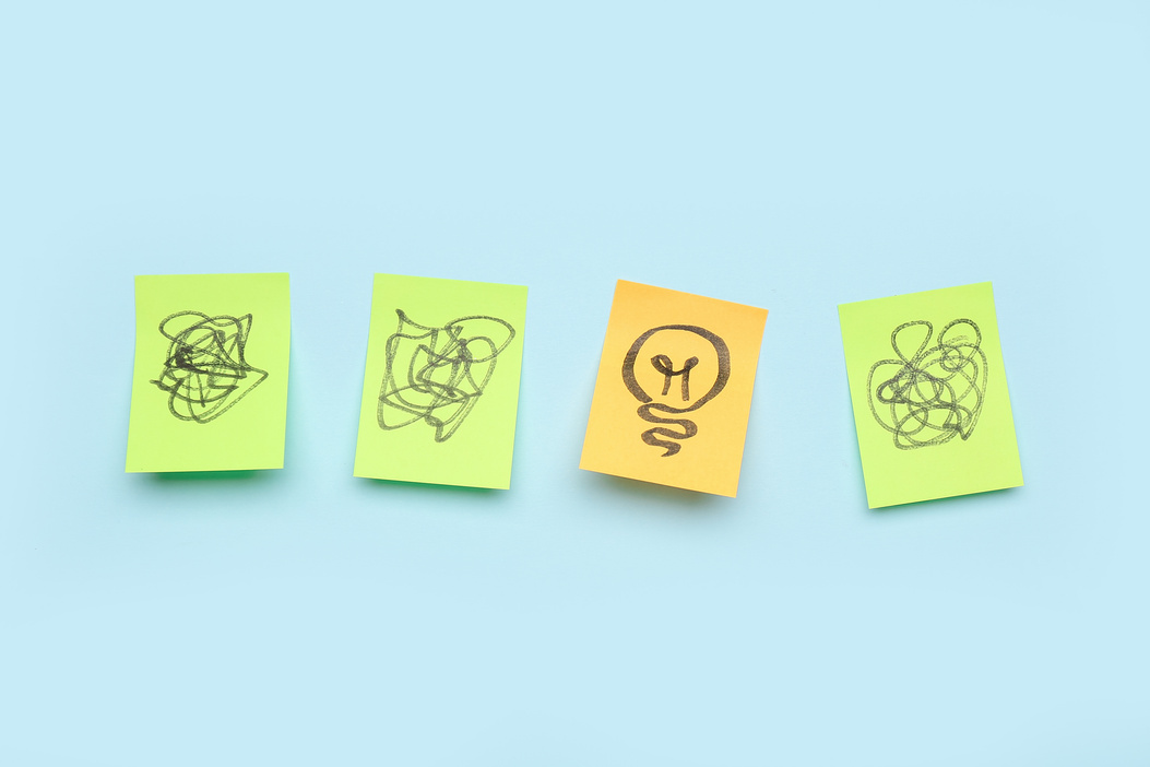 Sticky Papers with Drawn Light Bulb on Blue Background. Insight Concept